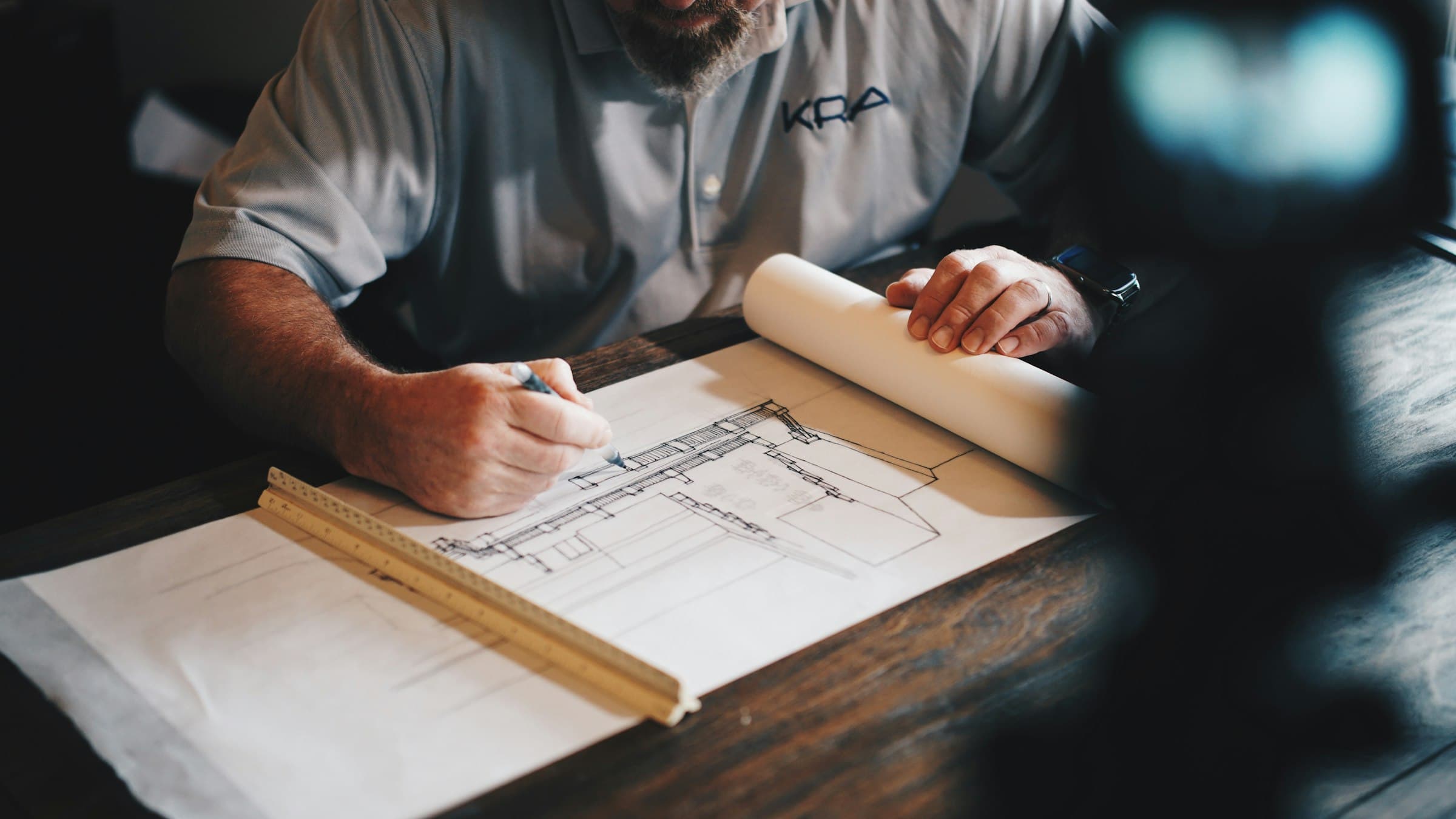 A site engineer marking up printed construction drawings